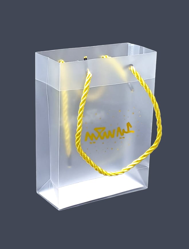 Transparent gift bags made of plastic bearing the phrase Happy Eid for Eid occasions, size (17CM*12.50*5.5) 12 pieces